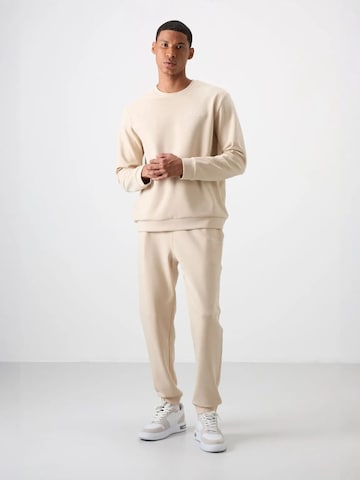 Tommy Life Joggingpak in Beige: voorkant