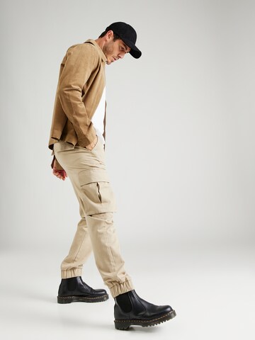 ABOUT YOU x Jaime Lorente Tapered Cargo trousers 'Adriano' in Beige