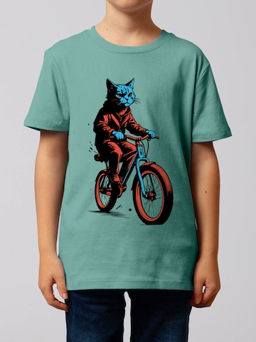 Maglietta ' Katze auf Fahrrad ' di watabout.kids in blu: frontale