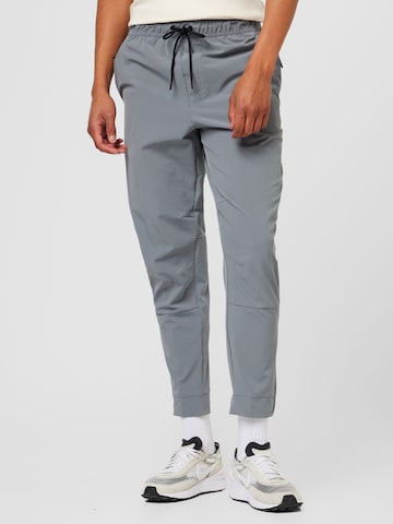 NIKE Tapered Sportsbukser 'UNLIMITED' i grå: forside