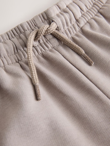 smėlio Next Plačios klešnės Kelnės