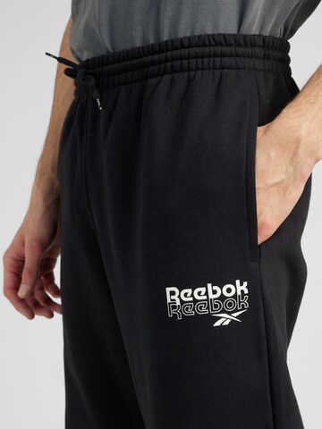 Reebok Tapered Workout Pants 'IDENTITY BRAND PROUD' in Black