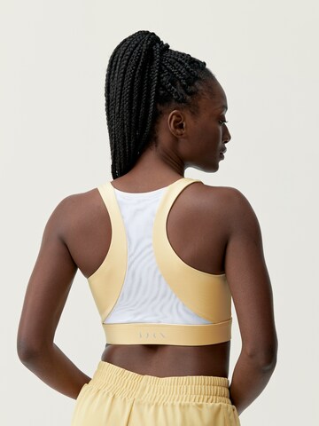 Haut de sport 'Padma 2.0' Born Living Yoga en jaune