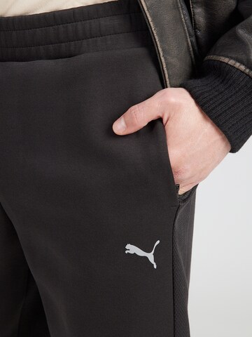 PUMA Regularen Športne hlače 'Evostripe' | črna barva