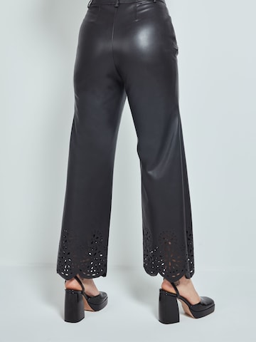 Katy Perry exclusive for ABOUT YOU Flared Trousers 'Nala' in Black