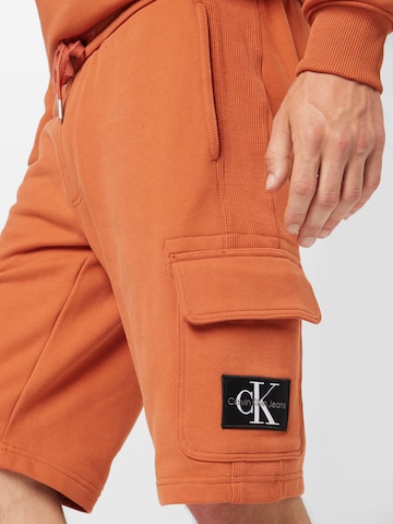 oranžinė Calvin Klein Jeans Standartinis Kelnės