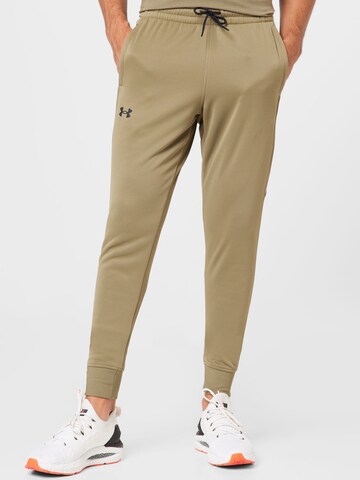 UNDER ARMOUR Tapered Workout Pants in Green: front