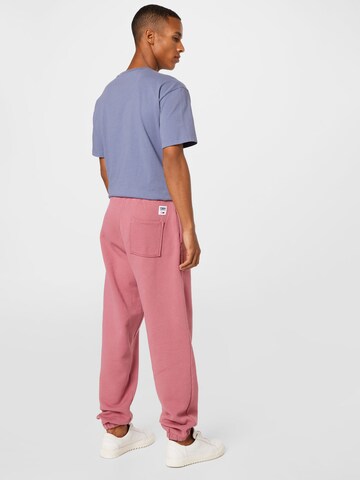 Tommy Jeans Zwężany krój Spodnie w kolorze różowy