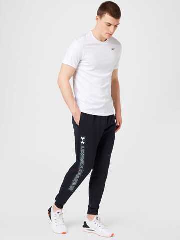 UNDER ARMOUR Tapered Urheiluhousut 'Rival' värissä musta