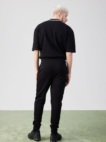 ABOUT YOU x Rewinside Tapered Pants in Black
