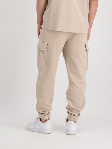 ALPHA INDUSTRIES Tapered Gargohousut 'Organics' värissä beige