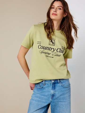Tricou de la Next pe verde: față