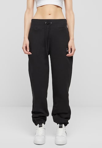 Karl Kani Tapered Pants in Black: front