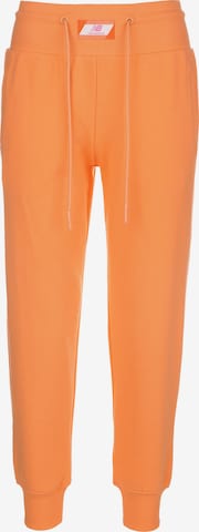 Tapered Pantaloni sportivi di new balance in arancione: frontale