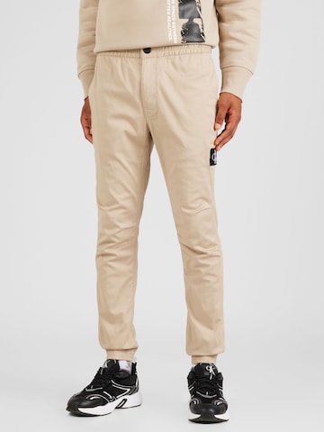 Calvin Klein Jeans Tapered Chino Pants in Beige: front
