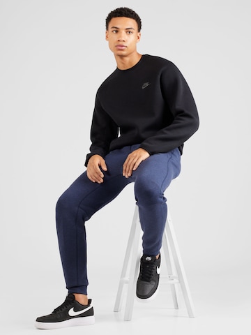 mėlyna Nike Sportswear Siaurėjantis Kelnės 'TECH FLEECE'