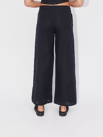 ABOUT YOU REBIRTH STUDIOS Wide leg Trousers 'Holiday' in Black