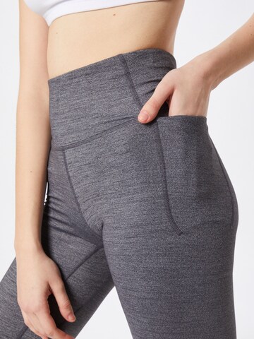 Skinny Pantaloni sportivi di UNDER ARMOUR in grigio