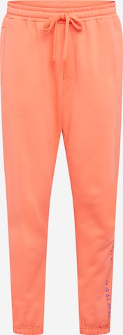 ABOUT YOU x Mero Lużny krój Spodnie 'Code' w kolorze pomarańczowy: przód