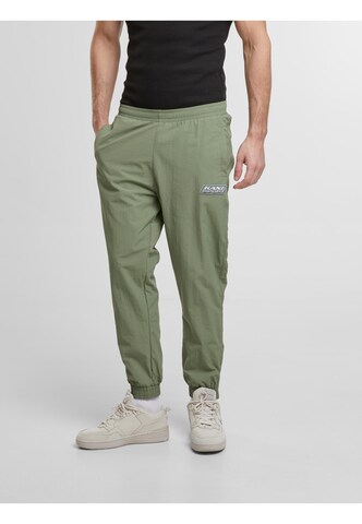 Karl Kani Tapered Pants in Green: front