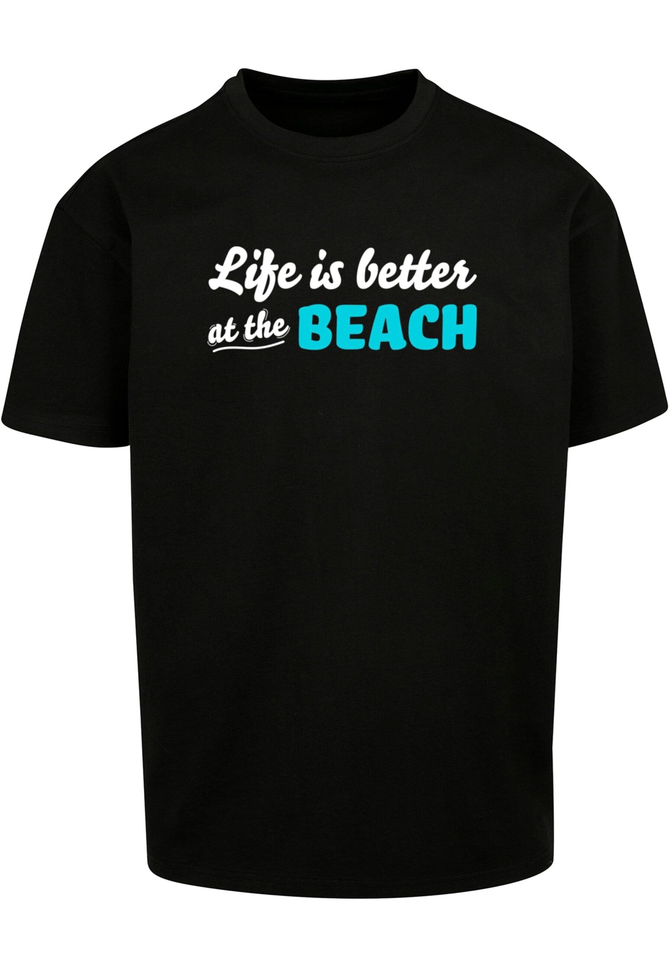 Merchcode T-Shirt 'Summer - Life Is Better At The Beach' in Schwarz: Vorderseite