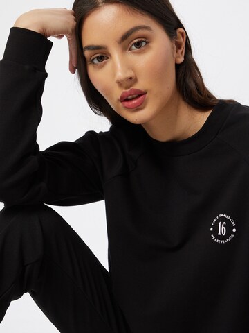 ABOUT YOU x GNTM Sweatshirt 'Xenia' in Black
