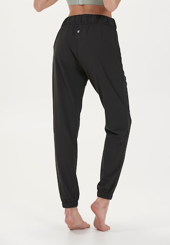 Athlecia - Tapered Pantalón deportivo 'Austberg' en negro