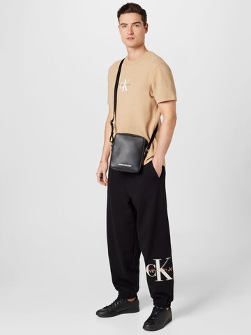 Calvin Klein Jeans Tapered Housut 'Archival' värissä musta