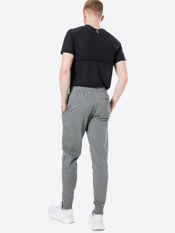 Effilé Pantalon de sport 'Rival' UNDER ARMOUR en gris