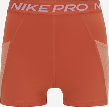 NIKE Workout Pants in Orange: front