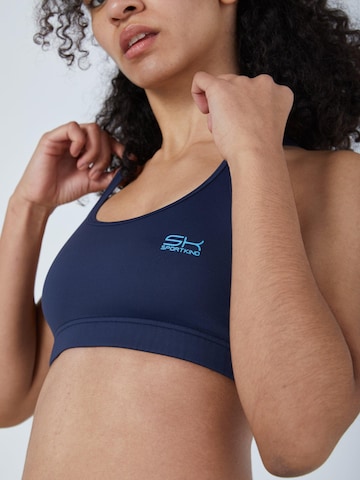 SPORTKIND Medium support Sport bh 'Crossed Straps' in Blauw