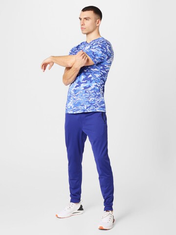 UNDER ARMOUR - Tapered Calças de desporto em azul