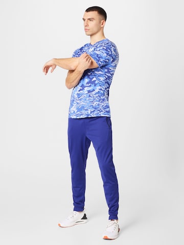 Effilé Pantalon de sport UNDER ARMOUR en bleu