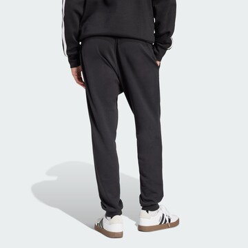 ADIDAS SPORTSWEAR Tapered Sports trousers 'FEELCOZY' in Black