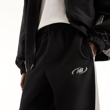 new balance - Tapered Pantalón en negro