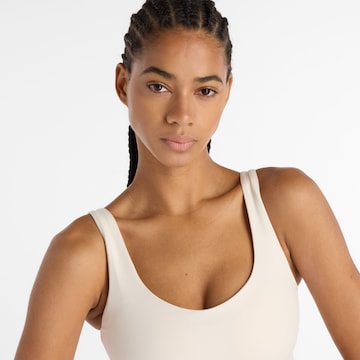Bustino Reggiseno sportivo 'Harmon' di new balance in bianco