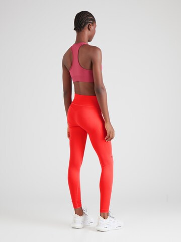 Skinny Pantaloni sportivi di UNDER ARMOUR in rosso
