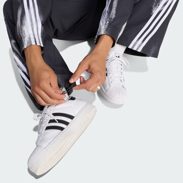 ADIDAS ORIGINALSLoosefit Hlače 'Adilenium 6' - crna boja