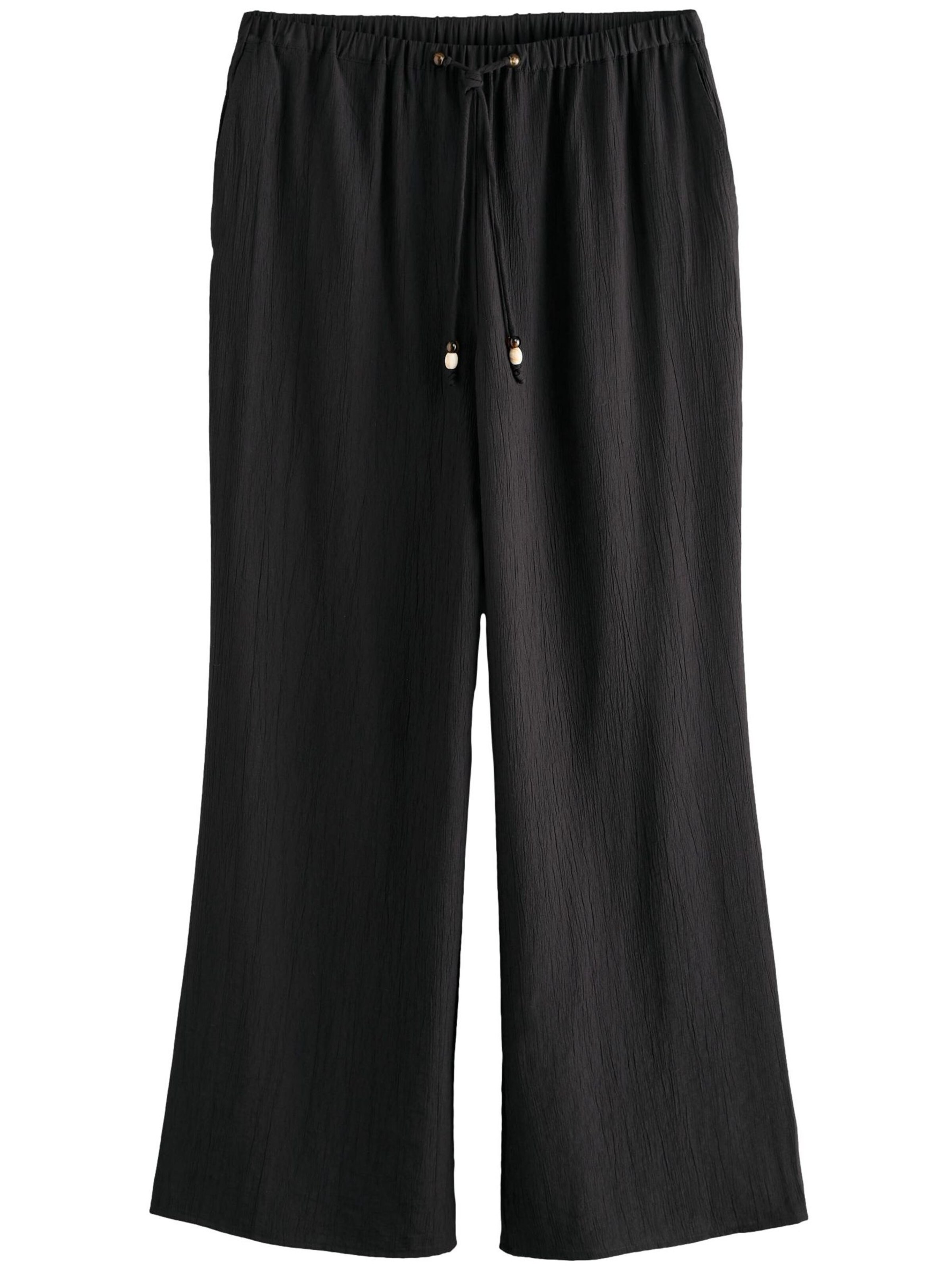 Next Szeroka nogawka Spodnie w kolorze czarny: przód