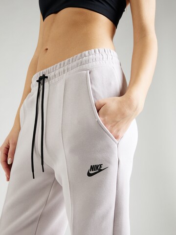 Nike Sportswear Zwężany krój Spodnie w kolorze fioletowy