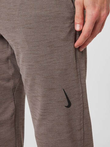 NIKE Tapered Workout Pants in Beige