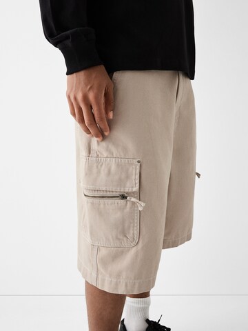 Bershka Loose fit Cargo trousers in Beige