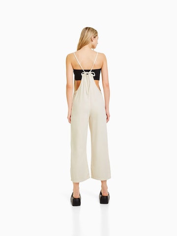 Bershka Loose fit Dungaree jeans in Beige