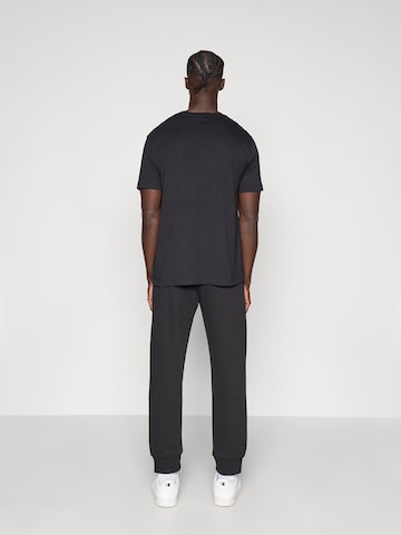 Champion Authentic Athletic Apparel Tapered Pants in Black