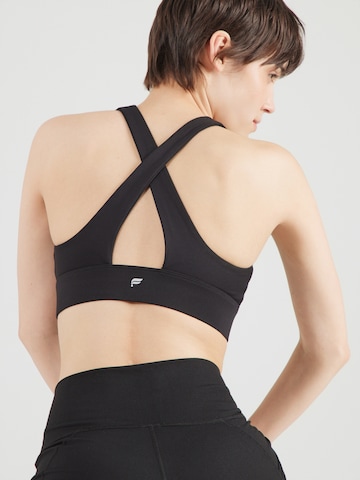 Fabletics Korzetová Sportovní podprsenka 'Oasis Twist' – černá