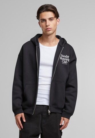 Another Cotton Lab Zip-Up Hoodie 'Sunday Running Club' in Black: front