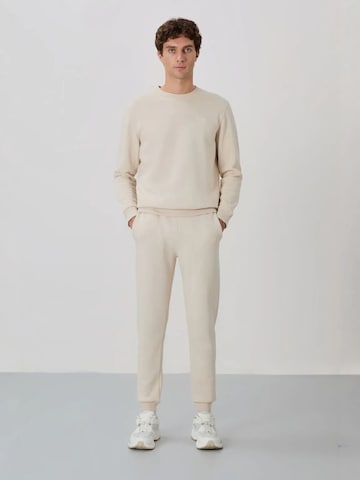 Survêtement Tommy Life en beige : devant