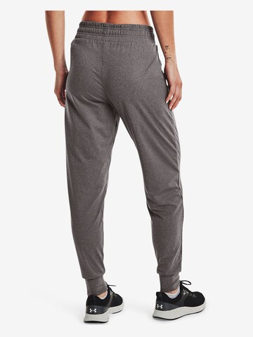 Effilé Pantalon de sport UNDER ARMOUR en gris