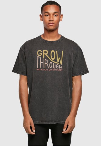 Merchcode T-Shirt 'Spring - Grow through 2' in Schwarz: Vorderseite
