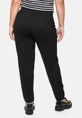 SHEEGO Tapered Pleat-Front Pants in Black